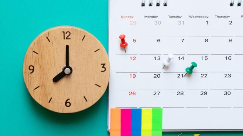 Image of clock, calendar, and organisational stationary