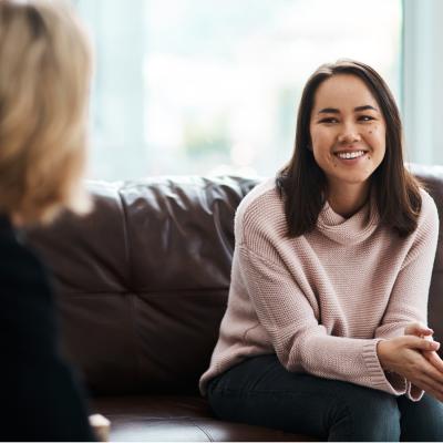 Woman sitting on a couch and smiling