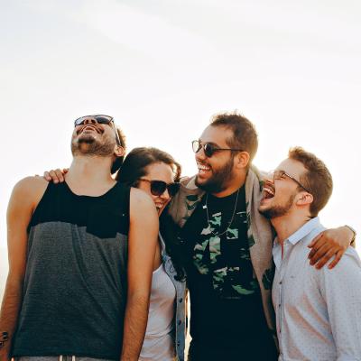 a group of people standing together and hugging and laughing