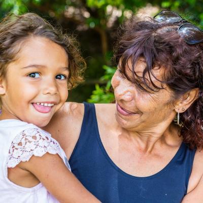 a woman holding a child and smiling
